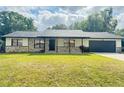 Charming single-story home with stone accents, well-maintained lawn, and a cozy front porch at 4385 Ne 2Nd Ct, Ocala, FL 34479