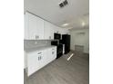 Modern kitchen featuring sleek white cabinets, updated countertops, and stainless steel appliances at 4385 Ne 2Nd Ct, Ocala, FL 34479
