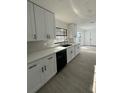 Modern kitchen featuring sleek white cabinets, updated countertops, and stainless steel appliances at 4385 Ne 2Nd Ct, Ocala, FL 34479
