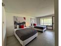 Well-lit bedroom featuring two beds, modern decor, and a view to the outside at 5245 W Irlo Bronson Memorial Hwy # 276, Kissimmee, FL 34746