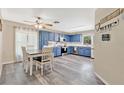 Bright kitchen with blue cabinets, stainless steel appliances, a window with natural light, and a dining table at 710 California Ave, St Cloud, FL 34769
