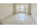 A bright, empty room featuring a bay window and tile flooring at 849 Long Bay Ct, Kissimmee, FL 34741