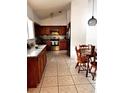 Cozy kitchen with wood cabinetry, granite counters, and stainless appliances at 849 Long Bay Ct, Kissimmee, FL 34741