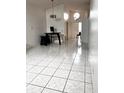 Open living area with neutral walls, tile floor and modern chandeliers at 849 Long Bay Ct, Kissimmee, FL 34741