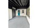 Covered carport area with a gray epoxy floor, offering shelter and convenience at 906 San Domingo Rd, Orlando, FL 32808