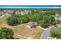 Expansive aerial view of the home with a large yard and mature trees in a residential neighborhood at 923 Gascony Ct, Kissimmee, FL 34759