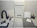 Close up of various modern finish samples including tile, cabinet door, faucet, and countertop at 1058 Cloud Ridge Ct, Mount Dora, FL 32757