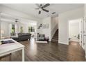 Open concept living room boasts wood-look tile floors, ceiling fan, and flows into kitchen/dining area at 11120 Whistling Pine Way, Orlando, FL 32832