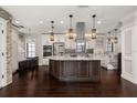 Spacious kitchen featuring a large island, custom cabinetry, and modern stainless steel appliances at 1116 Oak Pond Dr, Celebration, FL 34747