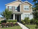 Charming two-story home with well-manicured landscaping and a welcoming front entrance at 11688 Founders St, Orlando, FL 32832