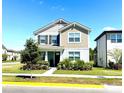 Charming two-story home with well-manicured lawn and lush landscaping at 11688 Founders St, Orlando, FL 32832
