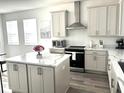 Bright kitchen with a large island, stainless steel appliances, and plenty of cabinet space at 11688 Founders St, Orlando, FL 32832