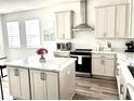 Bright, open kitchen featuring an island, stainless steel appliances, and quartz countertops at 11688 Founders St, Orlando, FL 32832