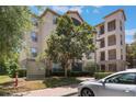 Exterior view of the condo building featuring balconies and a well-maintained landscape at 1375 Tuscana Ln # 1207, Davenport, FL 33896