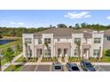 Inviting townhomes with stone accents, manicured landscaping, and convenient parking spaces at 1385 Peaceful Nature Way, Clermont, FL 34714