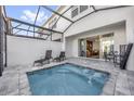 Relaxing patio with a private pool, comfortable lounge chairs, and access to the living area at 1385 Peaceful Nature Way, Clermont, FL 34714