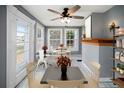 Bright sun room with large windows, tile floors, a ceiling fan, and seating for cafe-style dining at 1400 Florida Ave, St Cloud, FL 34769