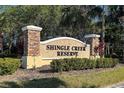 Attractive stone sign for Shingle Creek Reserve with well-maintained landscaping and mature trees at 1532 Angler Ave, Kissimmee, FL 34746