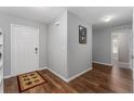 Inviting foyer with wood-look floors, neutral paint, and a door to the side and front door at 1532 Angler Ave, Kissimmee, FL 34746