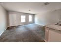 Spacious living room with lots of natural light and neutral carpeting at 158 Violet Ct, Poinciana, FL 34759