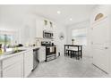 Well-lit kitchen features stainless steel appliances and a cozy breakfast nook at 2156 Merrybells Dr, Kissimmee, FL 34746