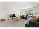 Spacious living room with neutral tones and sliding glass doors to the outdoors at 2156 Merrybells Dr, Kissimmee, FL 34746