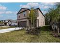 Lovely two-story home with a spacious driveway, a two-car garage and fresh landscaping at 2189 Teneroc Trl, Lakeland, FL 33801
