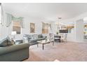 Bright living room featuring neutral carpet, light-colored walls, and stylish furniture, creating an inviting atmosphere at 253 Aldridge Ln, Davenport, FL 33897
