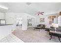 Spacious living area with connecting rooms offering flexibility, neutral carpet and a ceiling fan at 253 Aldridge Ln, Davenport, FL 33897