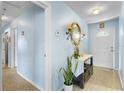 Charming entryway with terrazzo flooring, light blue walls and decorative console table at 3122 Eleuthera Ln, Orlando, FL 32827