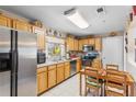 Functional kitchen featuring stainless steel appliances and a cozy dining area with natural light at 3122 Eleuthera Ln, Orlando, FL 32827