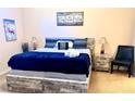 Comfortable main bedroom with modern decor, plush bedding, and stylish nightstands, offering a relaxing retreat at 314 Saddle Ridge Dr, Davenport, FL 33896