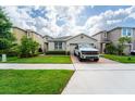 Well-maintained home featuring a brick driveway and lush lawn at 3298 Stratton Cir, Kissimmee, FL 34744