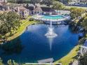 Beautiful aerial view of community pond with fountain and community pool at 4301 Lizshire Ln # 306, Orlando, FL 32822