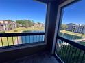 Balcony view of the pond with well-maintained community buildings and landscaping at 4301 Lizshire Ln # 306, Orlando, FL 32822