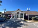 Community clubhouse featuring beautiful columns, fresh flowers, and ample parking at 4301 Lizshire Ln # 306, Orlando, FL 32822