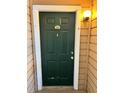 Green front door with gold accents in a well-maintained condo community at 4301 Lizshire Ln # 306, Orlando, FL 32822