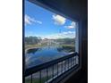 Scenic view from the balcony overlooking a tranquil pond and community buildings at 4301 Lizshire Ln # 306, Orlando, FL 32822