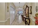 Inviting hallway with ceramic tile flooring, neutral paint, and decorative console table at 4337 Summer Breeze Way, Kissimmee, FL 34744
