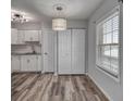 Dining area features wood-look floors, storage closet, and natural light from a large window at 525 Georgetown Dr # D, Casselberry, FL 32707