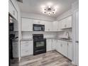 Updated kitchen with white cabinets, granite countertops, subway tile backsplash, and stainless steel appliances at 525 Georgetown Dr # D, Casselberry, FL 32707