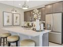 Modern kitchen with white countertops, stainless steel appliances and oversized kitchen island at 6413 Clover St, Lake Hamilton, FL 33851