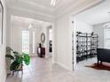 Bright foyer boasts modern lighting, neutral paint, and elegant tile flooring that flows into the open-concept living spaces at 684 San Augusto Dr, Poinciana, FL 34759