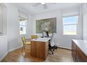 Bright office space with sleek desk, tile floors, and lots of natural light from two windows at 725 Lake Dell Rd, Dundee, FL 33838