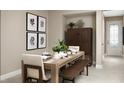 Inviting dining room with a wooden table set for a meal, alongside a cabinet and art at 730 Lake Dell Rd, Dundee, FL 33838