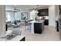 Inviting open-concept living room and kitchen with modern decor, a large window, and comfortable seating at 737 Lake Dell Rd, Dundee, FL 33838