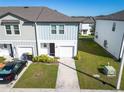 Attractive two-story home boasting a one-car garage, landscaped front yard, and charming curb appeal at 740 Madison Dr, Davenport, FL 33837