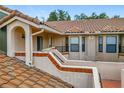 Exterior view of the townhome's second-story entrance, showcasing tiled accents and secure access at 7806 Sugar Brook Ct # 7806, Orlando, FL 32819