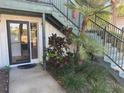 Charming condo entrance with a glass door, tasteful landscaping, and a welcoming pathway at 8 Buck Cir # 8, Haines City, FL 33844