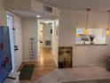 Inviting foyer with hardwood floors, a cozy rug, and a glimpse into the adjacent kitchen area at 8 Buck Cir # 8, Haines City, FL 33844